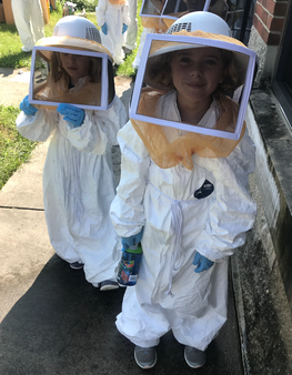 Bug Camp Particpants visiting Apiary wearing personal protective equipment.
